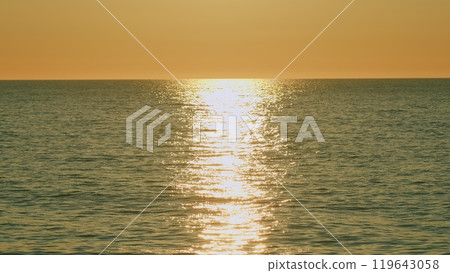 Nature Concept. Golden Light Of Sea Panorama. Sun Rising Over Ocean And Red Sky With View Of Sea Waves. Slow motion. Nature Concept. Golden Light Of Sea Panorama. Sun Rising Over Ocean And Red Sky With View Of Sea Waves. Slow motion. 119643058