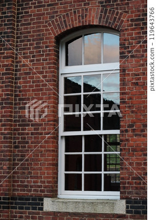 Scenery reflected in a red brick window 119643766