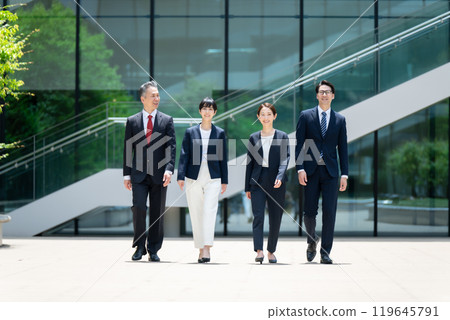 Business person walking outdoors Business person walking outdoors 119645791