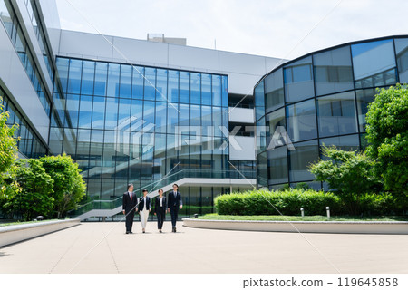 Business person walking outdoors Business person walking outdoors 119645858
