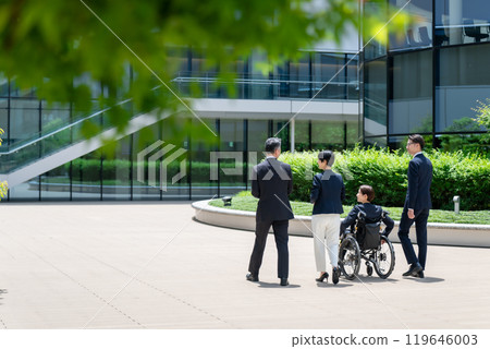 Business wheelchair team walking back view Business wheelchair team walking back view 119646003