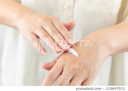 Woman applying hand cream 01 Woman applying hand cream 01 119647013