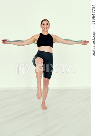 Fitness Trainer Demonstrating Resistance Band Exercise Fitness Trainer Demonstrating Resistance Band Exercise 119647784