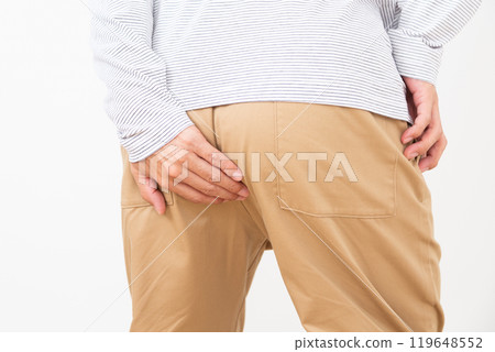 Middle-aged man holding his buttocks 119648552