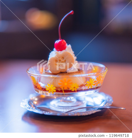 Pudding topped with pumpkin-shaped cookies 119649718