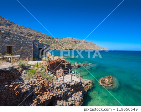 Emerald green beach and stone houses on cliffs (Plaka, Crete, Greece) Emerald green beach and stone houses on cliffs (Plaka, Crete, Greece) 119650549