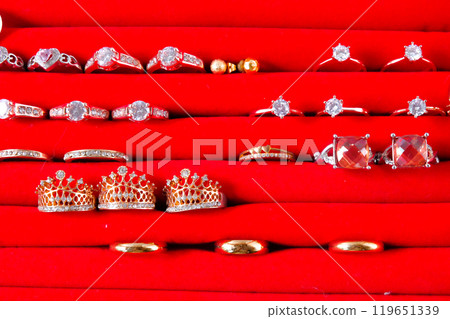 wedding rings or jewellery with golden ring in red box on white background. wedding rings or jewellery with golden ring in red box on white background. 119651339