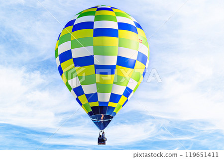 Colorful hot air balloon flying over blue sky with white clouds Colorful hot air balloon flying over blue sky with white clouds 119651411