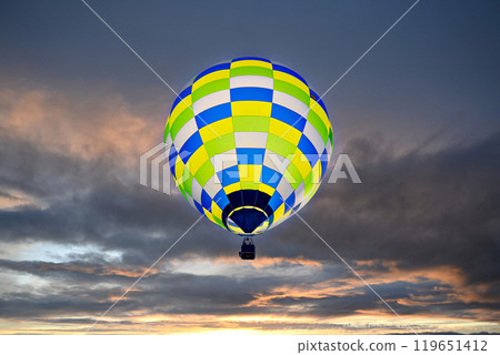 Colorful hot air balloon flying over blue sky with white clouds Colorful hot air balloon flying over blue sky with white clouds 119651412