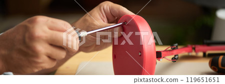 Hands with screwdriver fixing screws Hands with screwdriver fixing screws 119651651