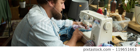 Stitching new pocket to blue jeans Stitching new pocket to blue jeans 119651663