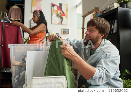 Man choosing new secondhand attire 119652062