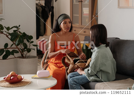 Mother Having Serious Conversation with Daughter in Living Room 119652111