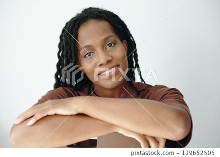 Portrait of Smiling Woman with Long Braided Hair Sitting 119652505