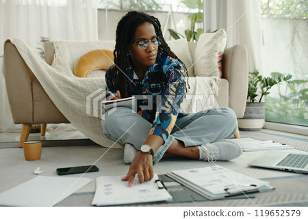 Concentrating African American Woman Working at Home 119652579