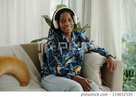Listening to Music with Headphones in Relaxed Setting Listening to Music with Headphones in Relaxed Setting 119652585