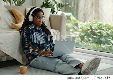 Working From Home While Sitting on Floor 119652616