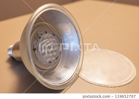 Close-up LED bulb with metallic reflector lens removed exposing components 119652787
