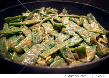 Pan-cooked green flat beans with garlic spices tahini rich creamy coating Pan-cooked green flat beans with garlic spices tahini rich creamy coating 119652788
