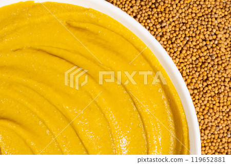 Mustard sauce and dry mustard seeds, top view. Mustard sauce and dry mustard seeds, top view. 119652881