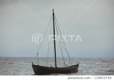 Ancient Viking ship in the evening sea in Denmark 119653739