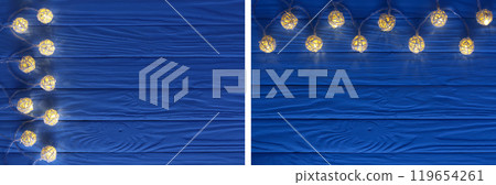christmas garland lights on blue wooden background with copy space for your text. Top view 119654261