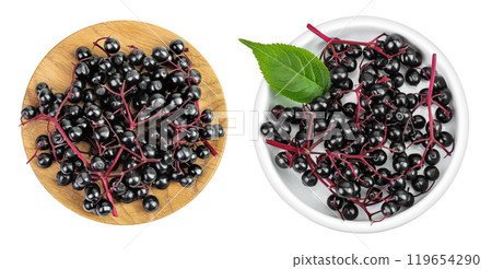 Ripe black elderberry or elder with green leaves in wooden bowl isolated on a white background. Sambucus 119654290