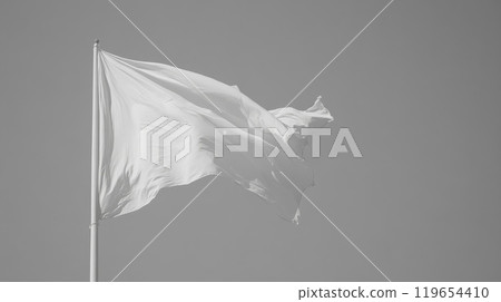 White flag waving on flagpole with clear sky background, surrender 119654410