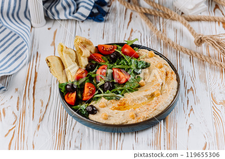 Mediterranean hummus plate with fresh vegetables, olives, and pita bread for a perfect meal Mediterranean hummus plate with fresh vegetables, olives, and pita bread for a perfect meal 119655306