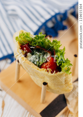 Fresh pita stuffed with vegetables, herbs, and sauce, perfect for a healthy and quick meal option Fresh pita stuffed with vegetables, herbs, and sauce, perfect for a healthy and quick meal option 119655364