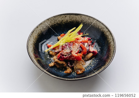 Stir fried vegetables and meat topped with sesame seeds, creating a vibrant and flavorful Asian dish Stir fried vegetables and meat topped with sesame seeds, creating a vibrant and flavorful Asian dish 119656052