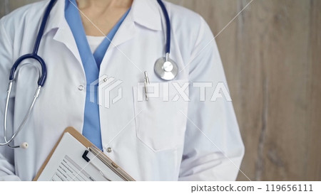 Confident healthcare professional with stethoscope. Close-up of a medical doctor in white coat with medication history record form and clipboard. Medicine concept 119656111