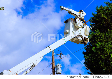 Works safely power line repairs being carried out with help of mobile lift. Works safely power line repairs being carried out with help of mobile lift. 119657624