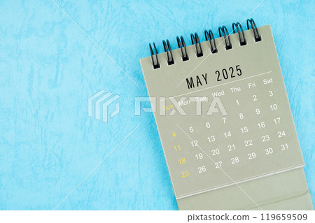 May 2025 desk calendar on blue background. 119659509