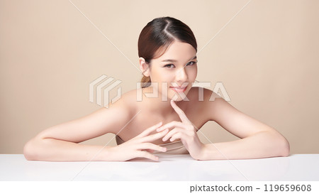 Beautiful young asian woman with clean fresh skin on beige background, Face care, Facial treatment, Cosmetology, beauty and spa, Asian women portrait. Beautiful young asian woman with clean fresh skin on beige background, Face care, Facial treatment, Cosmetology, beauty and spa, Asian women portrait. 119659608