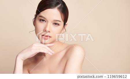 Beautiful young asian woman with clean fresh skin on beige background, Face care, Facial treatment, Cosmetology, beauty and spa, Asian women portrait. Beautiful young asian woman with clean fresh skin on beige background, Face care, Facial treatment, Cosmetology, beauty and spa, Asian women portrait. 119659612