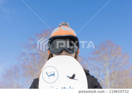 Young woman holding a snowboard Snowboard image Young woman holding a snowboard Snowboard image 119659732