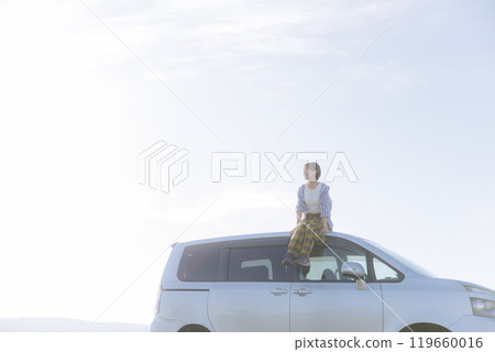 Woman standing in a car Woman standing in a car 119660016