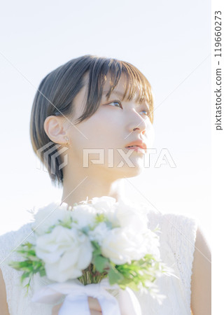 A woman holding a bouquet 119660273
