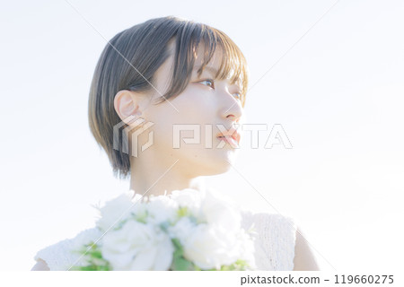 A woman holding a bouquet 119660275