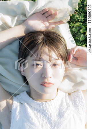 A woman relaxing on the meadow 119660503