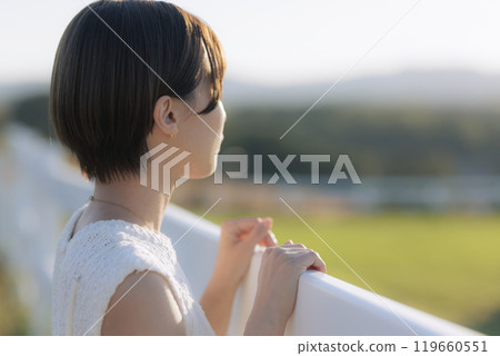 A woman looking up at the sky 119660551