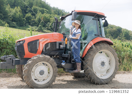 Young woman riding a tractor Young woman riding a tractor 119661352