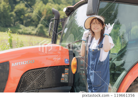 Young woman riding a tractor Young woman riding a tractor 119661356