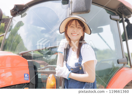 Young woman riding a tractor Young woman riding a tractor 119661360