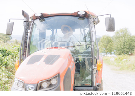 Young woman riding a tractor Young woman riding a tractor 119661448