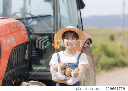 Young woman harvesting potatoes Young woman harvesting potatoes 119661759