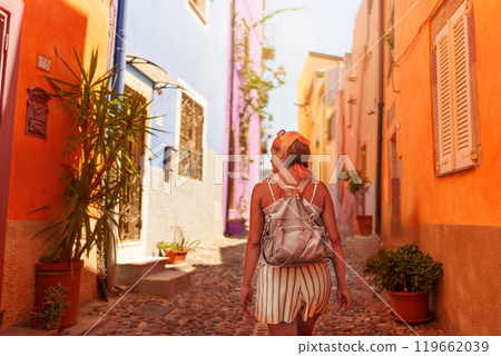 Female traveler walking through the streets of Bosa 119662039
