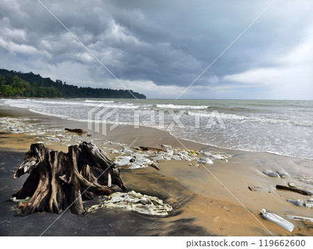 Trash scattered all over the beach close to the ocean Trash scattered all over the beach close to the ocean 119662600