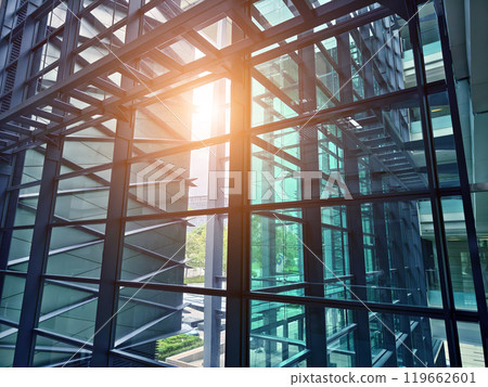 A modern tall building that features a significant amount of glass A modern tall building that features a significant amount of glass 119662601